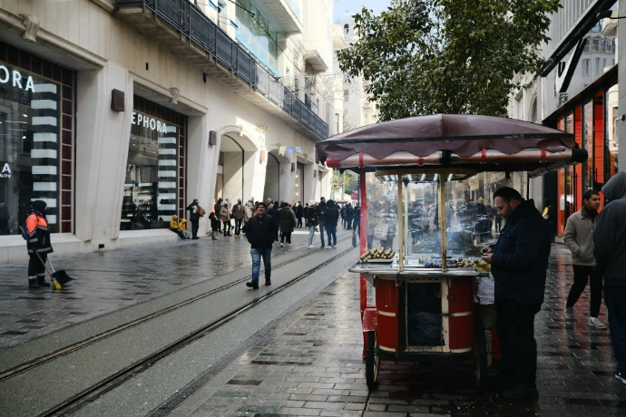 a street scene with people and a street vendor